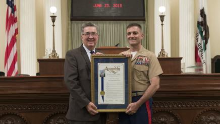 Assemblymember Cooley presenting Assembly Resolution to Colonel Bruce Pitman on his retirement from the USMC.